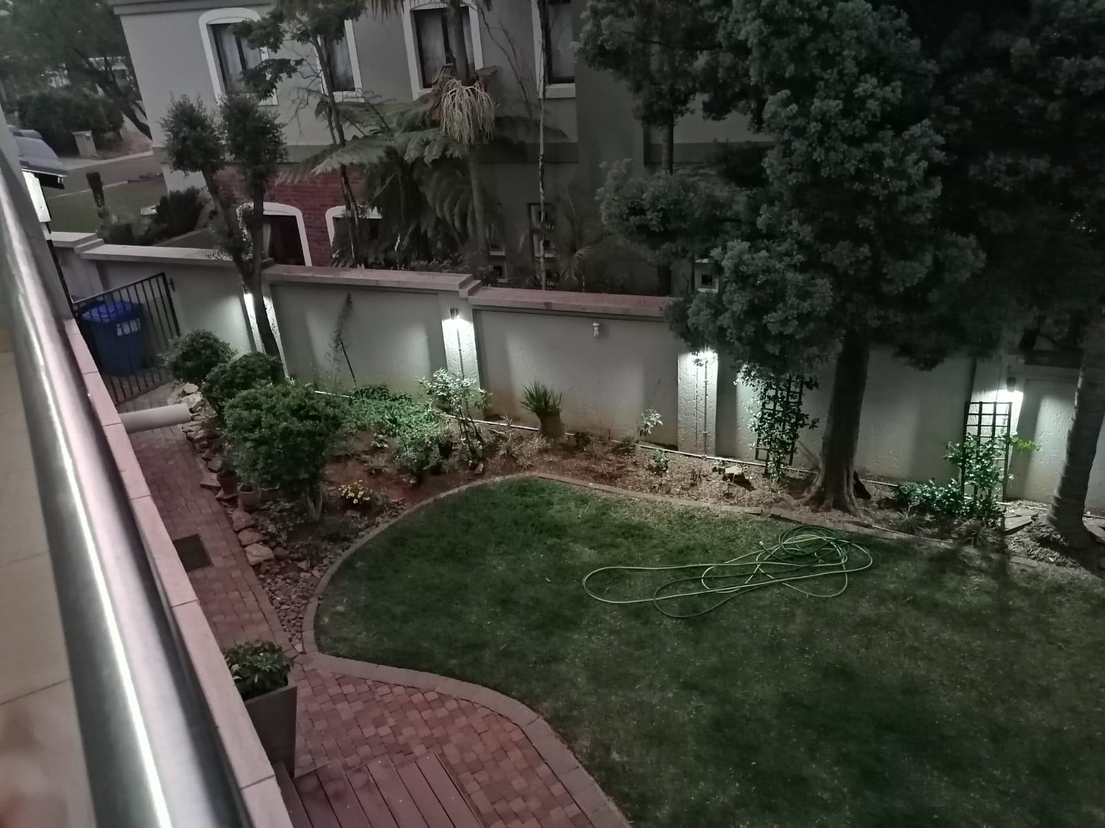 Security perimeter lights along a garden wall